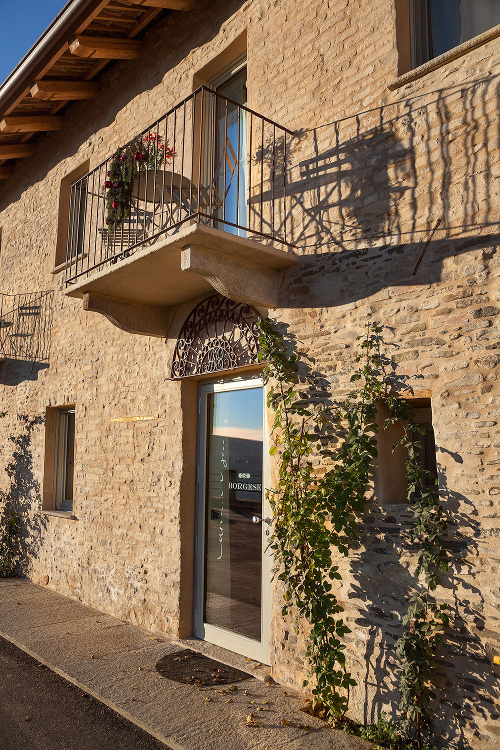 A nineteenth-century Langhe stone wall on the façade of the inn.